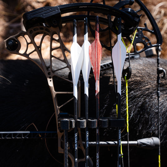 4 UV 1K arrows in a quiver with the 3rd from the left coated in blood